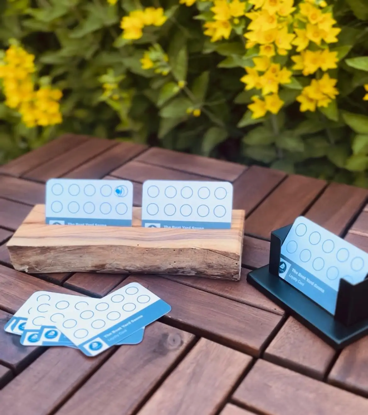 The Boat Yard Sauna loyalty cards displayed on a wooden table