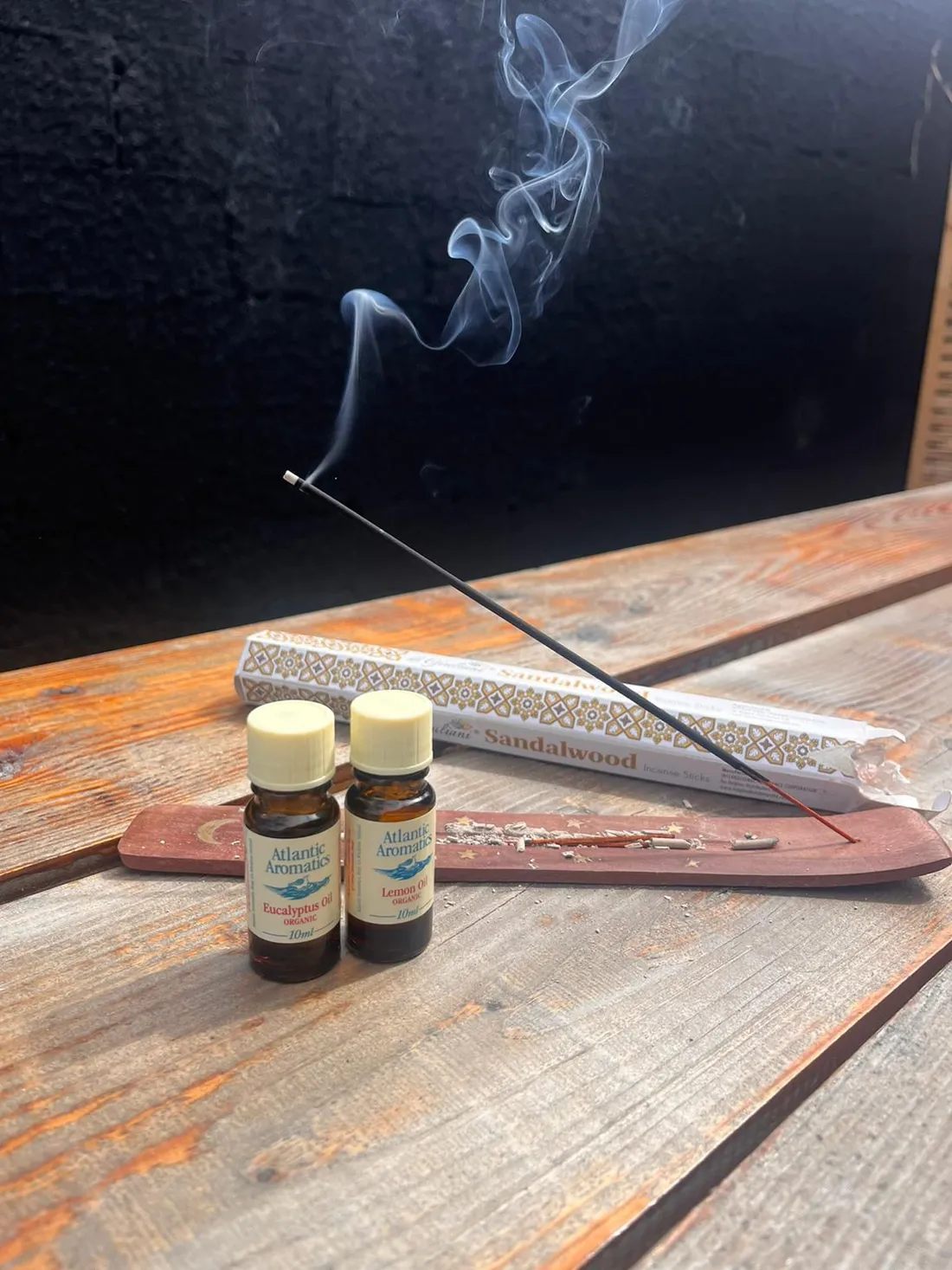 Ritual oils and incense on cedar wood